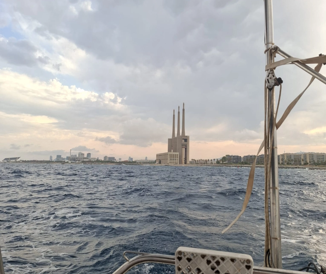 Group of people enjoying a luxury sailing trip near the city at sunset