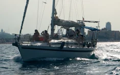 Group of people enjoying a sunset sailing trip off the coast of Barcelona