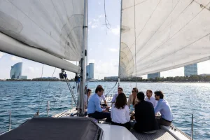 Group of professionals in a business meeting on board a sailing boat off the coast of Barcelona