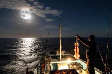 Night fishing by boat under the full moon